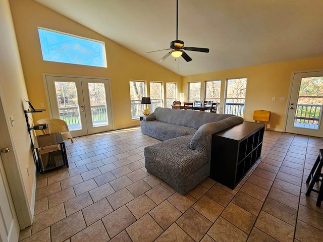 living room with tile patterned floors, ceiling fan, a healthy amount of sunlight, and high vaulted ceiling