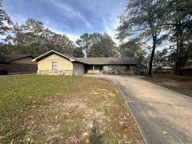 ranch-style house with a garage and a front lawn