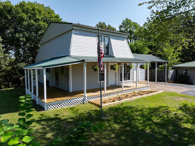 country-style home featuring covered porch and a front lawn