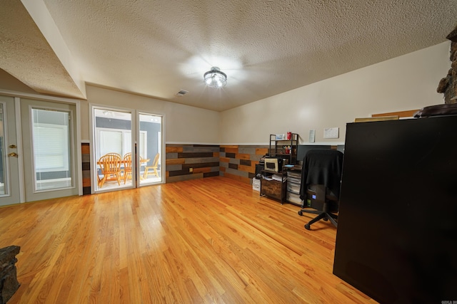 home office featuring a textured ceiling and light wood-type flooring