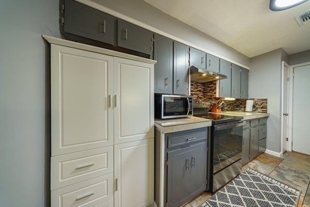 kitchen with backsplash, gray cabinetry, and appliances with stainless steel finishes