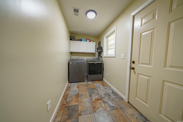 laundry room featuring cabinets and washing machine and clothes dryer