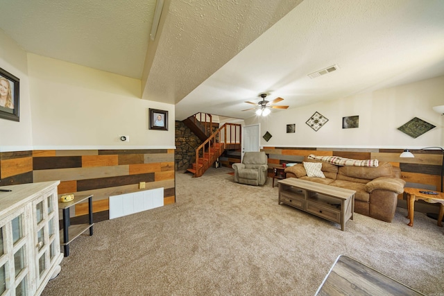 living room featuring carpet, a textured ceiling, and ceiling fan