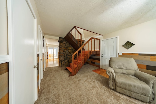 living area with carpet floors and a textured ceiling