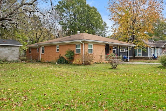 rear view of house featuring a lawn