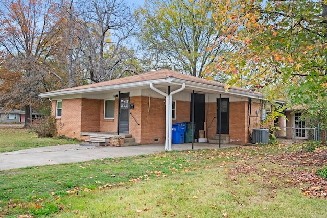 ranch-style home featuring central air condition unit and a front lawn