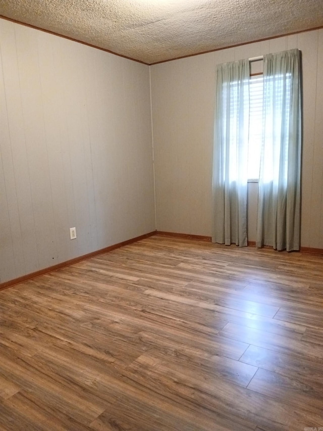 802 Casey St, Leslie, AR 72645 - spare room featuring wood finished floors and a textured ceiling
