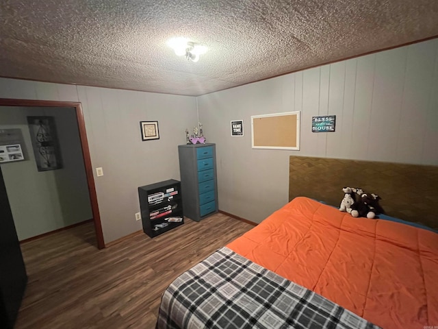 bedroom featuring a textured ceiling and hardwood / wood-style flooring