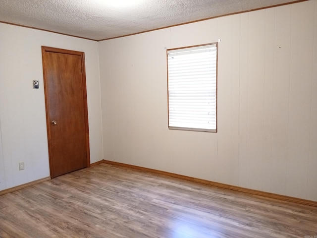 802 Casey St, Leslie, AR 72645 - empty room featuring ornamental molding, wood finished floors, and a textured ceiling