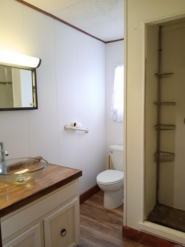 802 Casey St, Leslie, AR 72645 - bathroom featuring vanity, wood finished floors, a shower stall, toilet, and ornamental molding