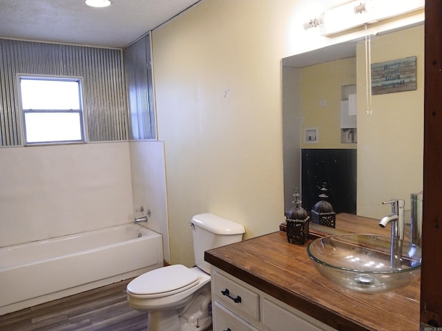 802 Casey St, Leslie, AR 72645 - bathroom featuring vanity, toilet, wood finished floors, and shower / tub combination