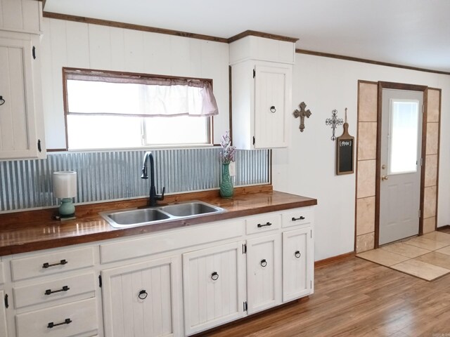 802 Casey St, Leslie, AR 72645 - kitchen with a sink, white cabinetry, plenty of natural light, light wood finished floors, and crown molding