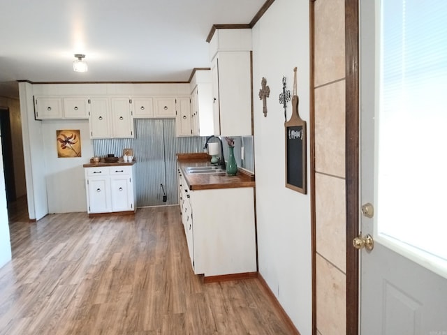 802 Casey St, Leslie, AR 72645 - kitchen featuring a sink, light wood-style floors, and white cabinets