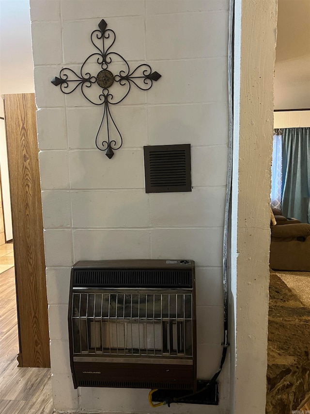 interior details featuring wood-type flooring and heating unit