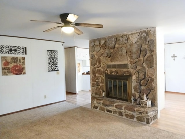 802 Casey St, Leslie, AR 72645 - unfurnished living room featuring a ceiling fan, a fireplace, carpet floors, and baseboards