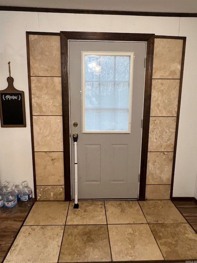 doorway with light tile patterned floors