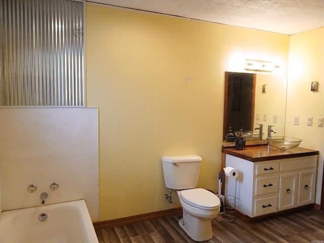 802 Casey St, Leslie, AR 72645 - full bath featuring wood finished floors, a bathtub, vanity, toilet, and baseboards