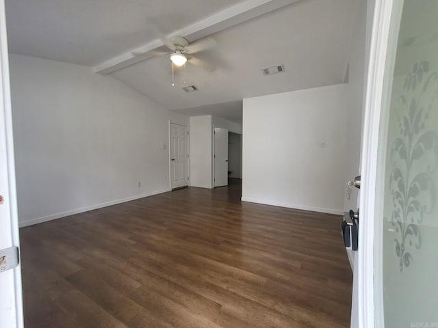 empty room featuring vaulted ceiling with beams, ceiling fan, and dark wood-type flooring