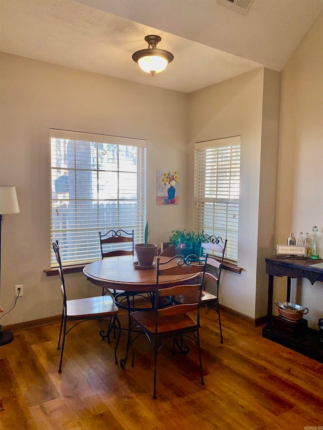 dining area with plenty of natural light and wood-type flooring