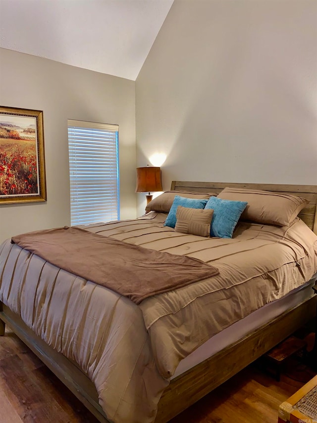 bedroom featuring wood-type flooring and vaulted ceiling