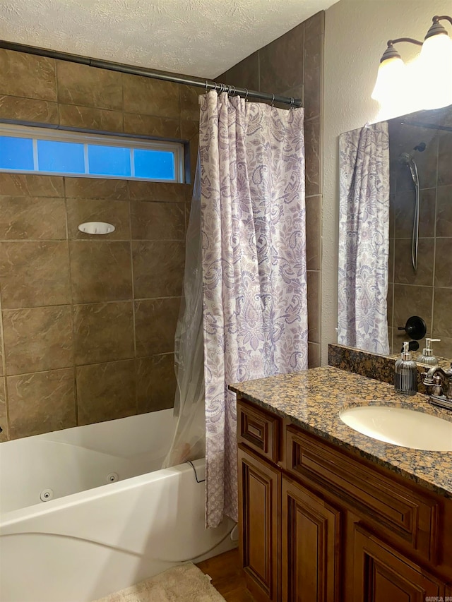 bathroom featuring vanity, a textured ceiling, and shower / bath combo with shower curtain