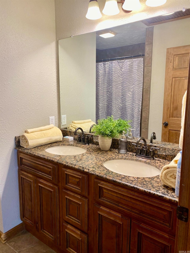 bathroom featuring tile patterned flooring and vanity