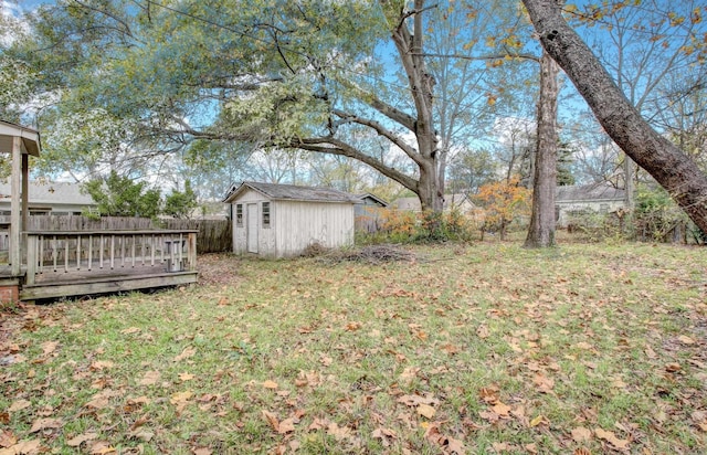 view of yard with a storage unit and a wooden deck