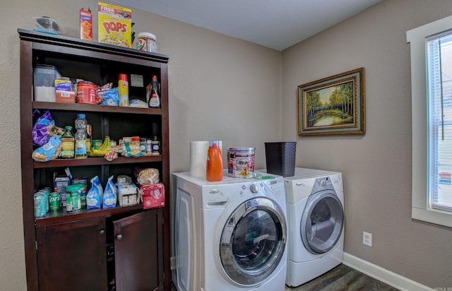 washroom featuring cabinets, dark hardwood / wood-style flooring, and washing machine and dryer