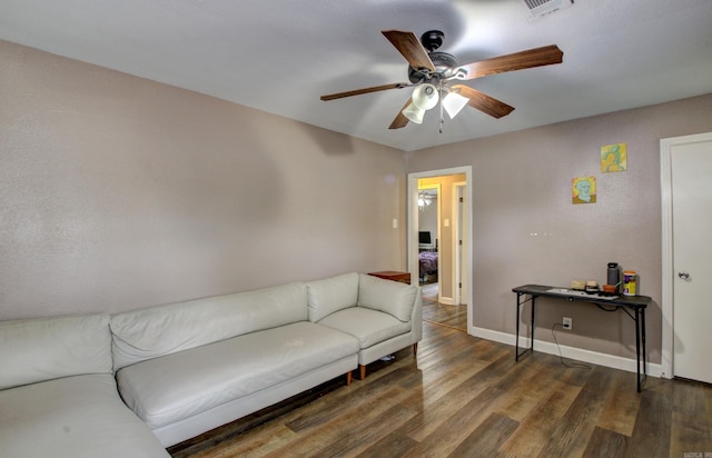 living room featuring dark hardwood / wood-style floors and ceiling fan