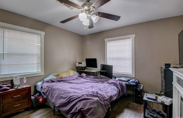 bedroom with ceiling fan and wood-type flooring