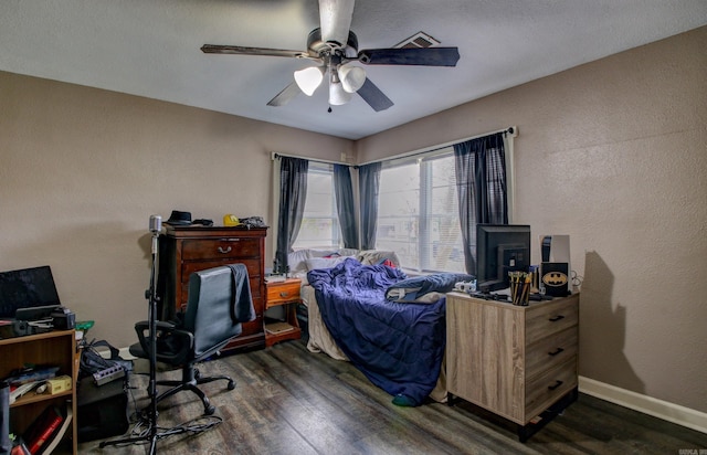 bedroom with ceiling fan and dark wood-type flooring