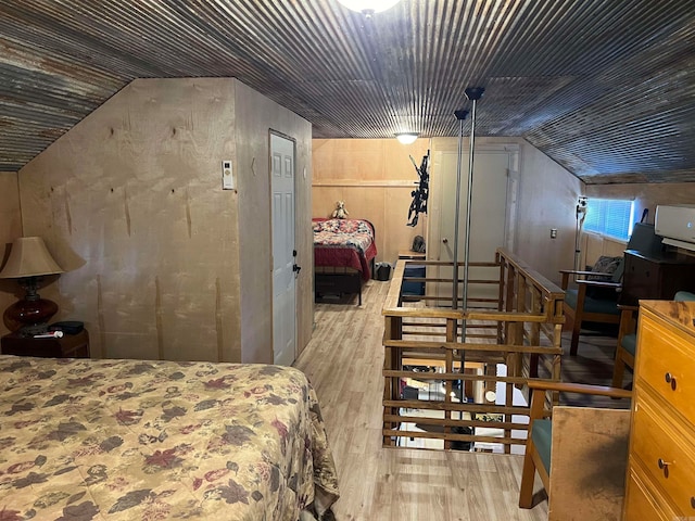 bedroom featuring vaulted ceiling and light hardwood / wood-style flooring