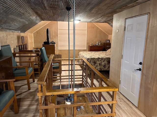 wine room featuring light hardwood / wood-style flooring and lofted ceiling