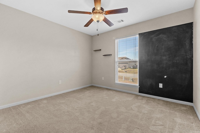 spare room with light carpet and ceiling fan