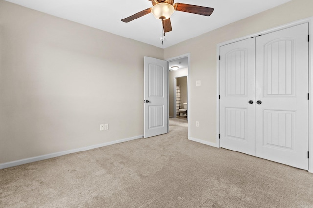 unfurnished bedroom featuring ceiling fan, a closet, and light carpet