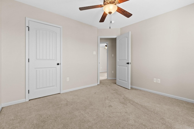 unfurnished bedroom with light carpet, a closet, and ceiling fan