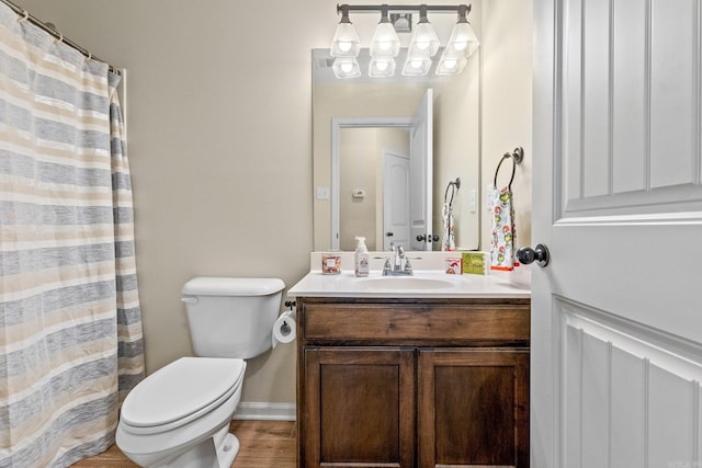 bathroom with vanity, wood-type flooring, and toilet