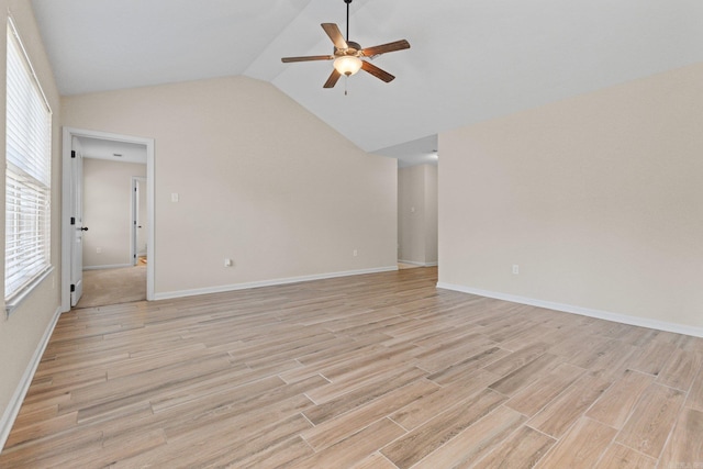 interior space with ceiling fan, lofted ceiling, and light wood-type flooring