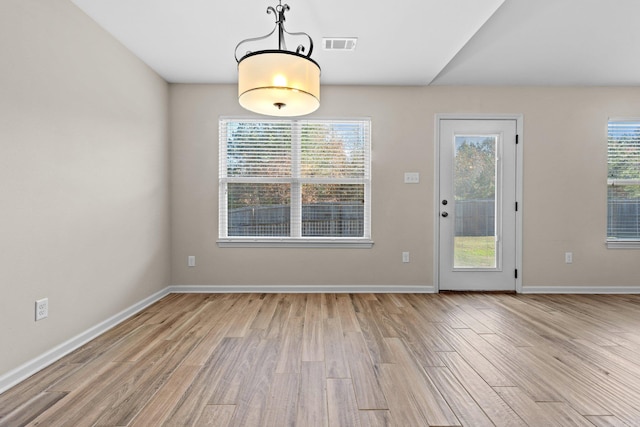 unfurnished dining area featuring light hardwood / wood-style floors