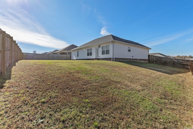 rear view of house with a lawn