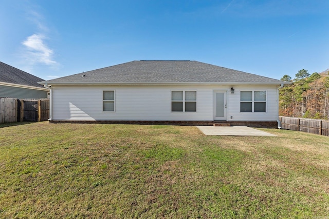 back of property featuring a yard and a patio area