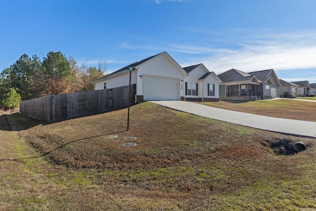 view of front of house with a front yard and a garage