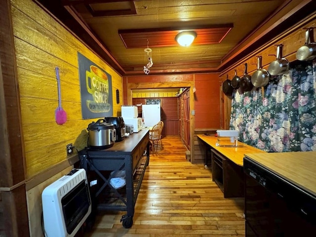 interior space featuring dishwasher, light hardwood / wood-style flooring, heating unit, wood walls, and wood ceiling