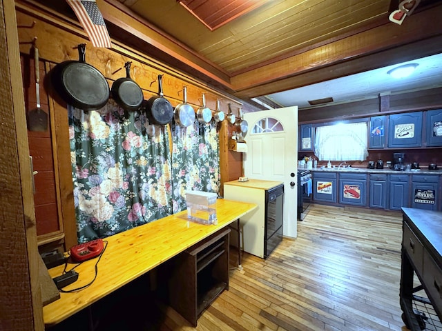 kitchen with light hardwood / wood-style flooring, stainless steel stove, wood ceiling, and sink