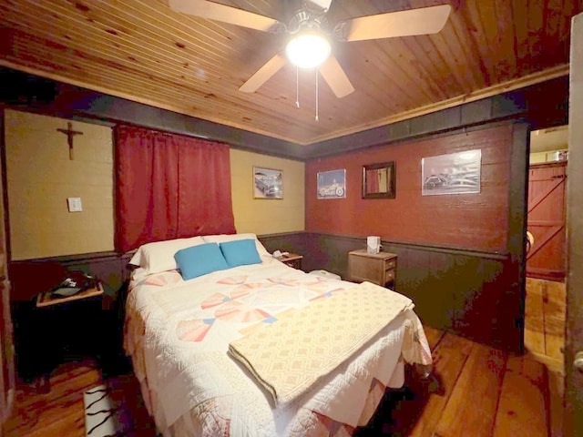 bedroom with ceiling fan, hardwood / wood-style floors, and wood ceiling