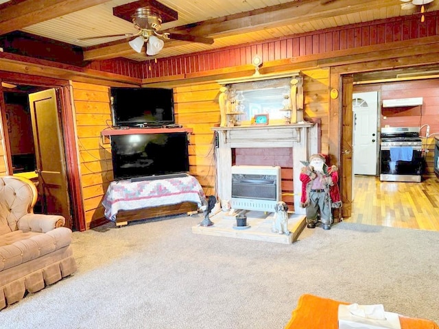 living room with ceiling fan, beamed ceiling, hardwood / wood-style floors, wooden walls, and wood ceiling