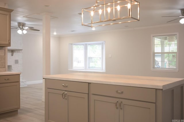 kitchen with light wood-type flooring, plenty of natural light, crown molding, and ceiling fan