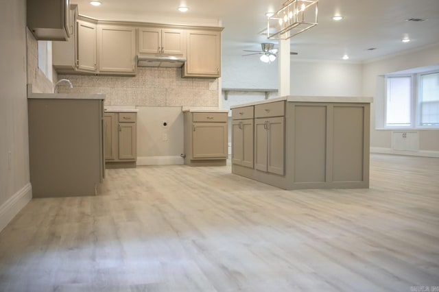 kitchen with decorative backsplash, gray cabinetry, ceiling fan, crown molding, and light hardwood / wood-style flooring