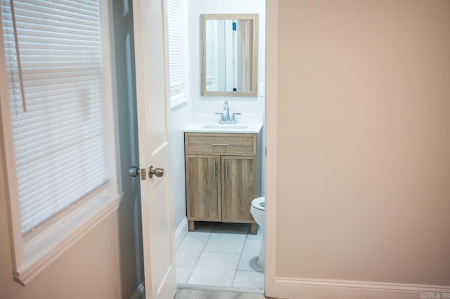 bathroom featuring tile patterned floors, vanity, and toilet