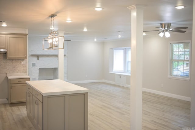 kitchen featuring decorative backsplash, a healthy amount of sunlight, ceiling fan with notable chandelier, and light hardwood / wood-style floors